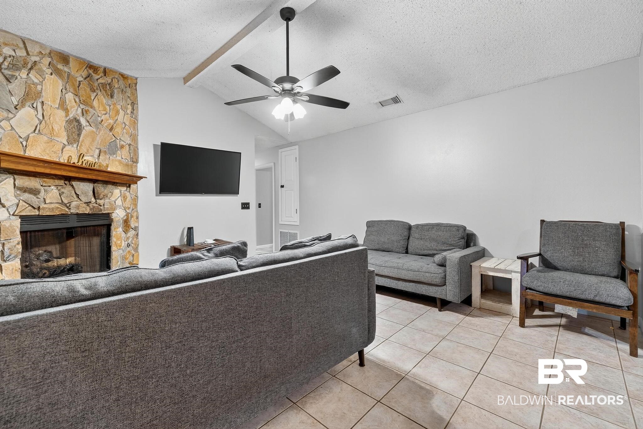 21895 2nd Street Silverhill, AL 36576 - Photo 19 of 43 Living area featuring a light tile floors, a fireplace, and ceiling fan