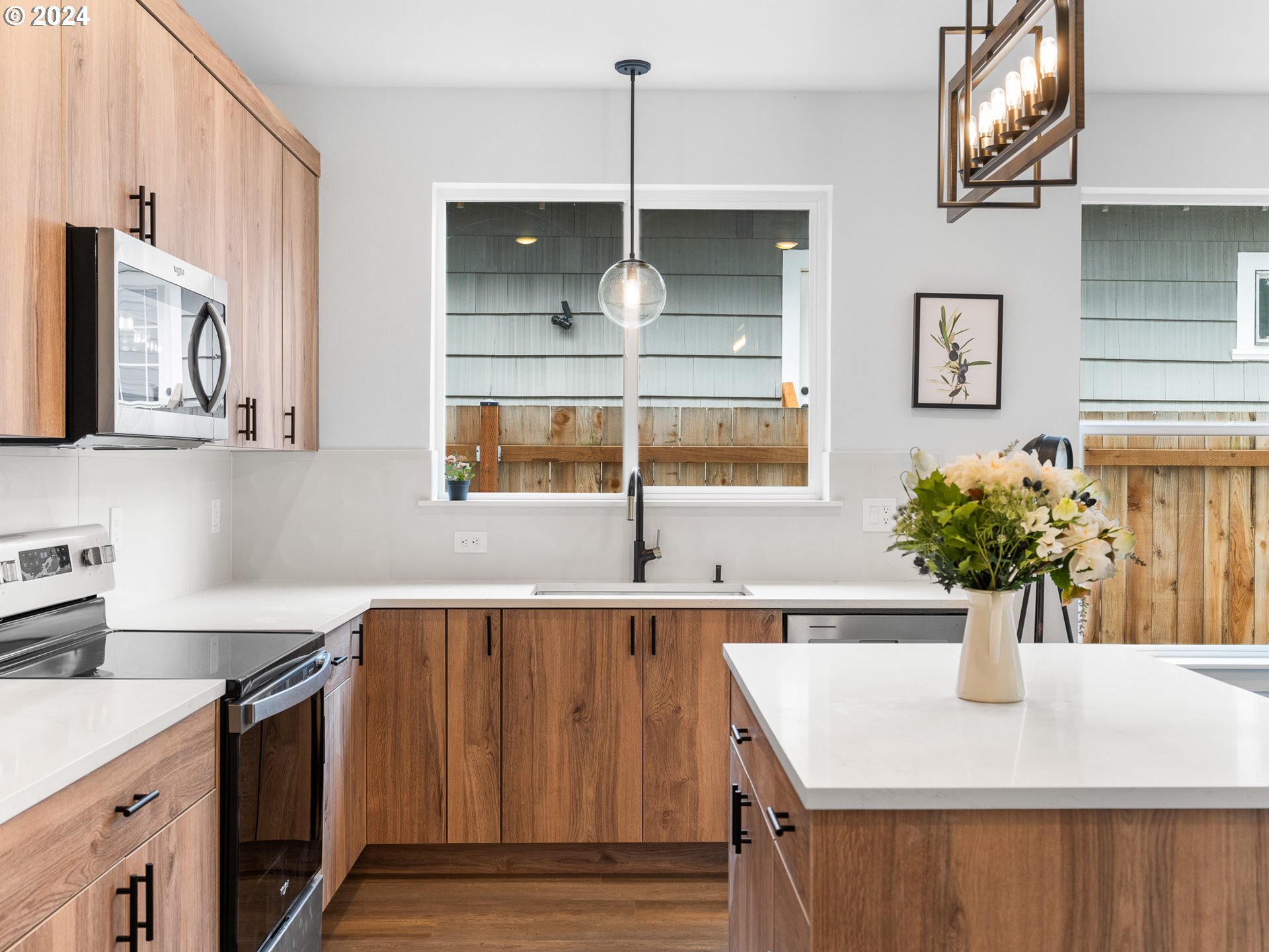 7740 Southeast Long Street, Unit A Portland, OR 97206 - Photo 11 of 23 a kitchen with a sink a counter space and cabinets