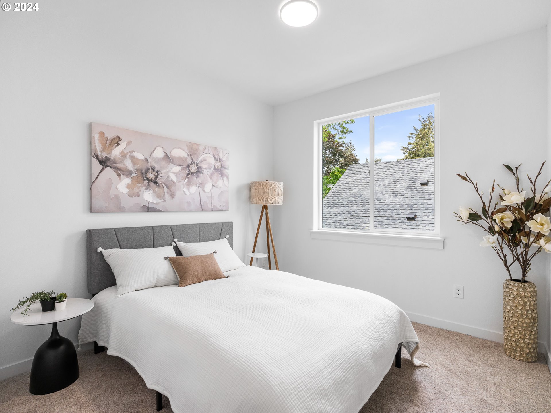 7740 Southeast Long Street, Unit A Portland, OR 97206 - Photo 14 of 23 a bedroom with a bed and a painting on the wall