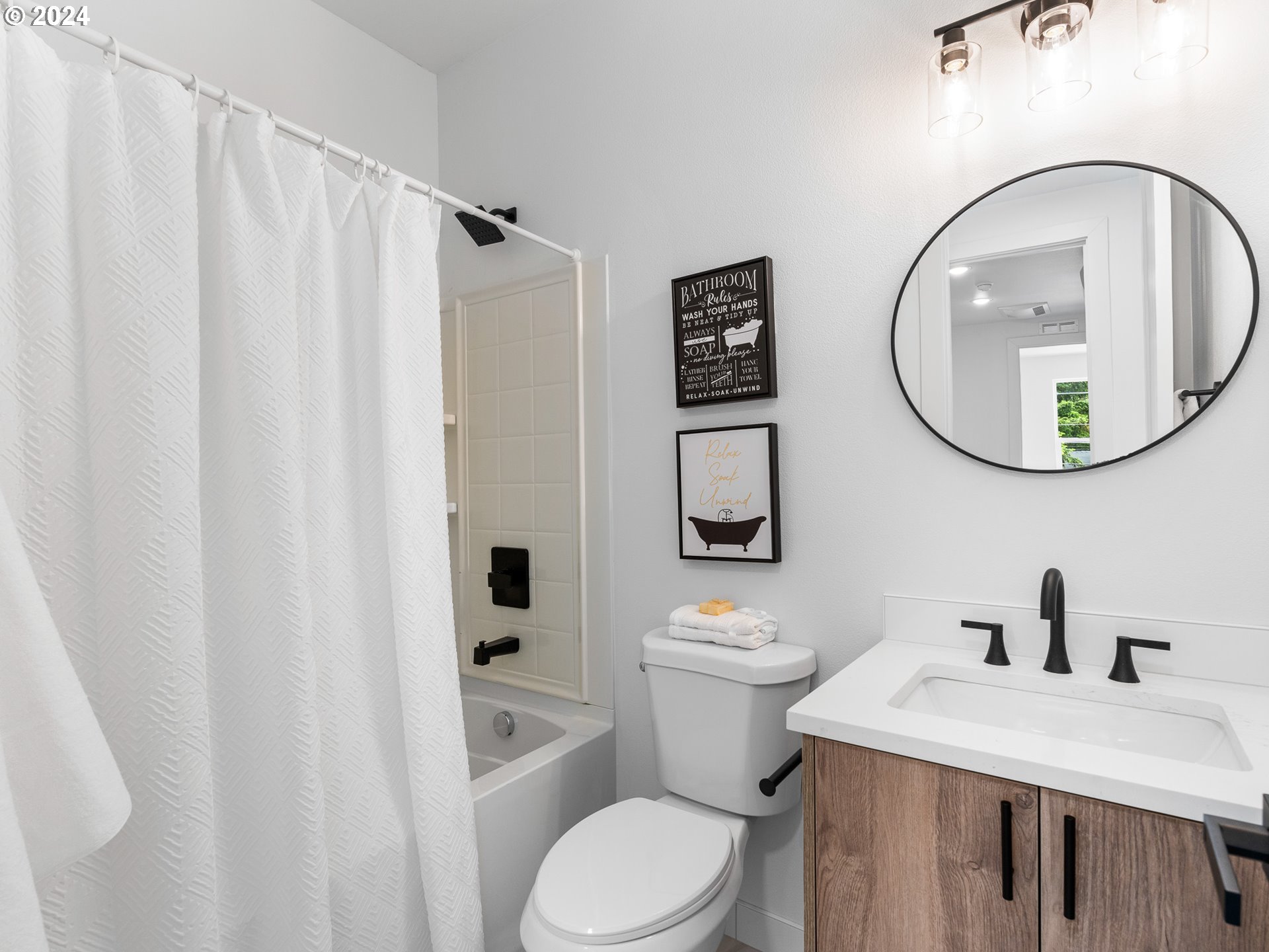 7740 Southeast Long Street, Unit A Portland, OR 97206 - Photo 16 of 23 a white toilet sitting next to a bathroom sink