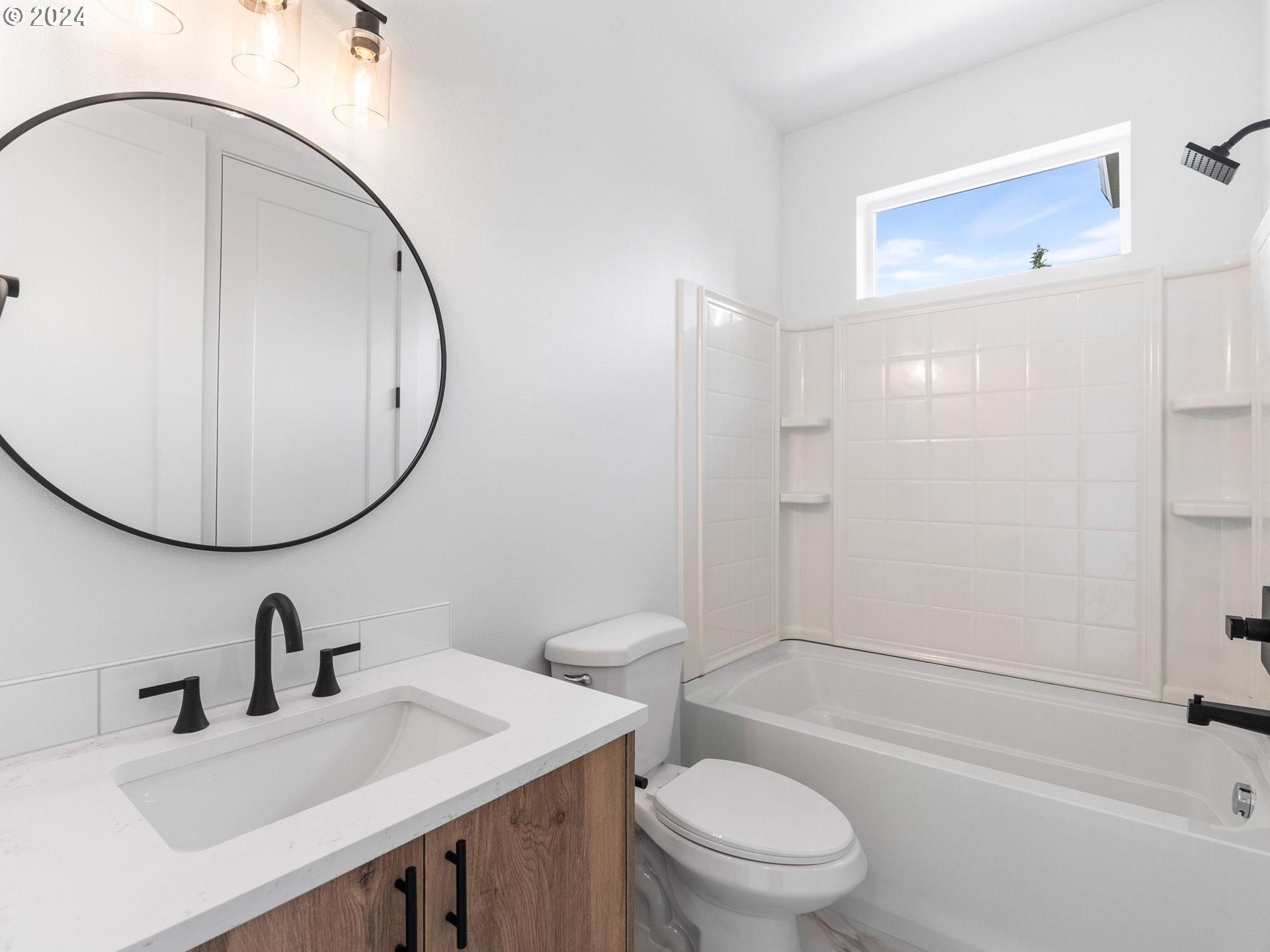 7740 Southeast Long Street, Unit A Portland, OR 97206 - Photo 18 of 23 a bathroom with a sink a toilet and a mirror