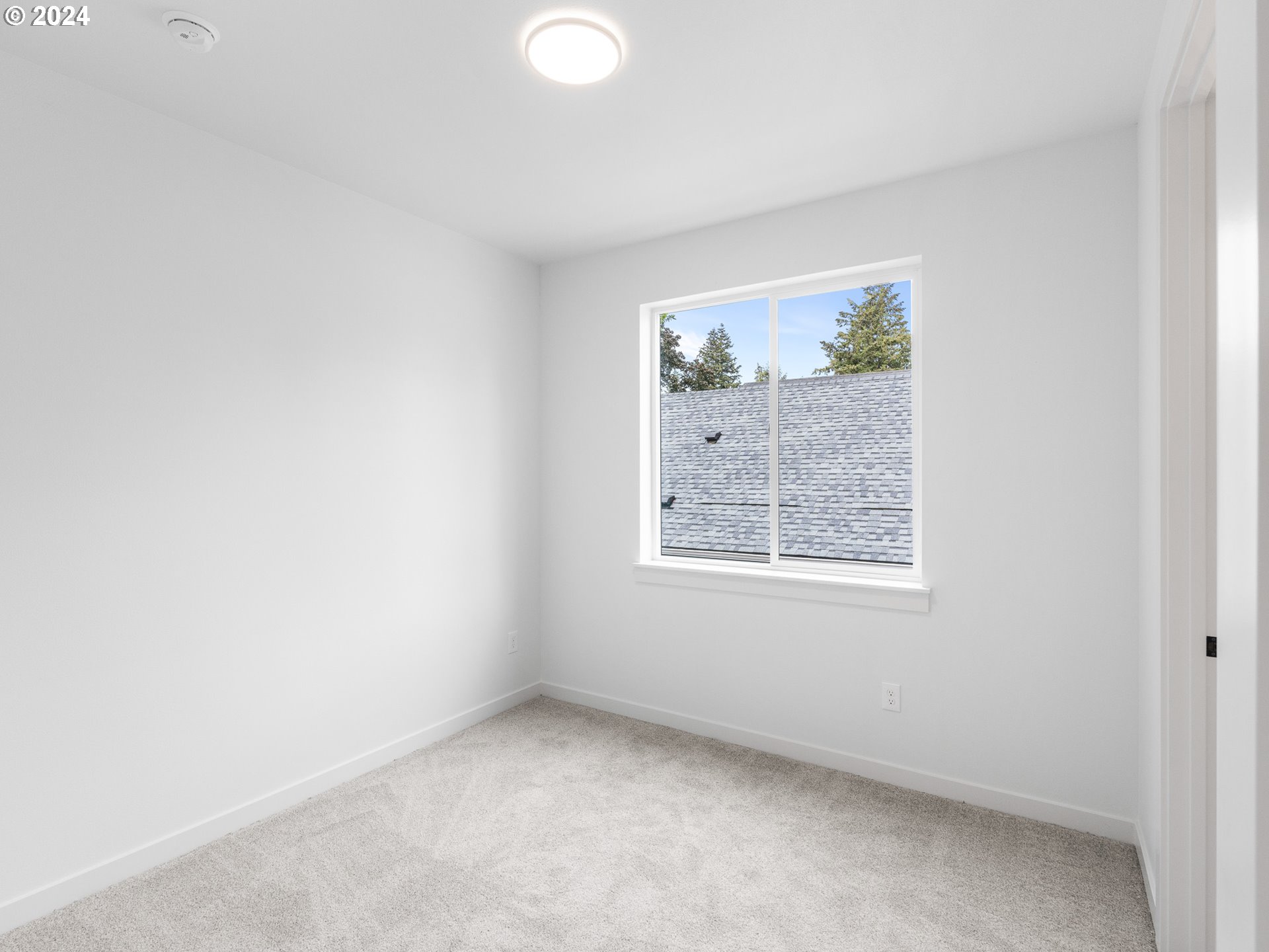 7740 Southeast Long Street, Unit A Portland, OR 97206 - Photo 19 of 23 an empty room with windows