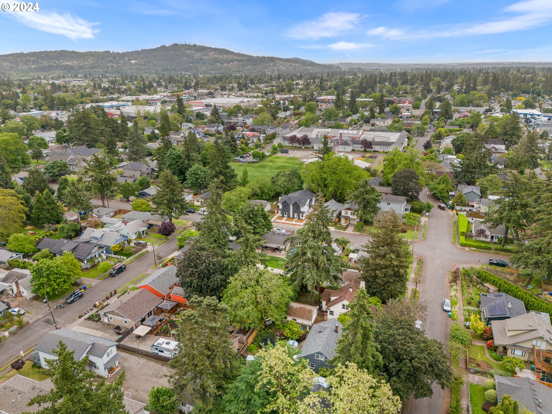 7740 Southeast Long Street, Unit A Portland, OR 97206 - Photo 22 of 23 an aerial view of residential houses with outdoor space and trees