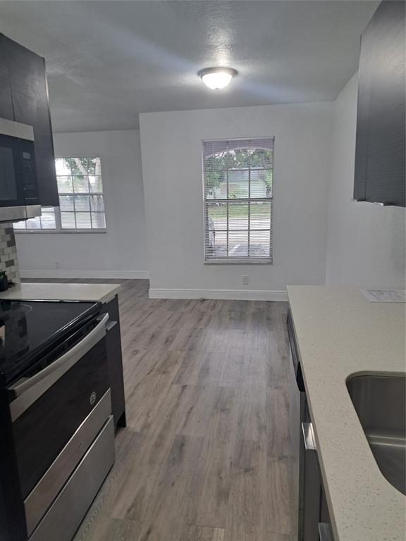 980 Southwest 76th Avenue, Unit 3 Pompano Beach, FL 33068 - Photo 11 of 32 a kitchen with wooden floors and a stove