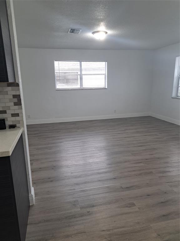 980 Southwest 76th Avenue, Unit 3 Pompano Beach, FL 33068 - Photo 14 of 32 an empty room with wooden floor and windows