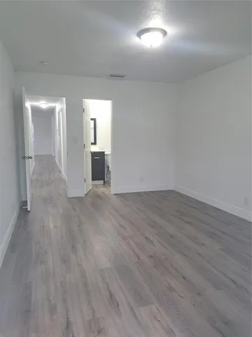 a view of a room with wooden floor