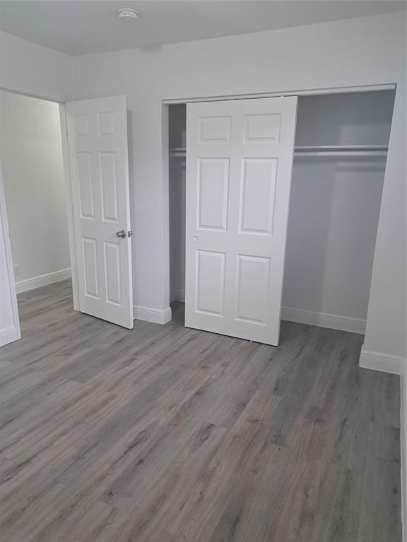 980 Southwest 76th Avenue, Unit 3 Pompano Beach, FL 33068 - Photo 21 of 32 a view of an empty room with wooden floor