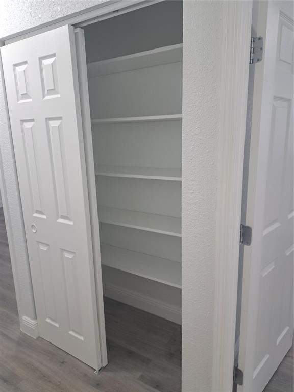 980 Southwest 76th Avenue, Unit 3 Pompano Beach, FL 33068 - Photo 22 of 32 a view of walk in closet with empty racks