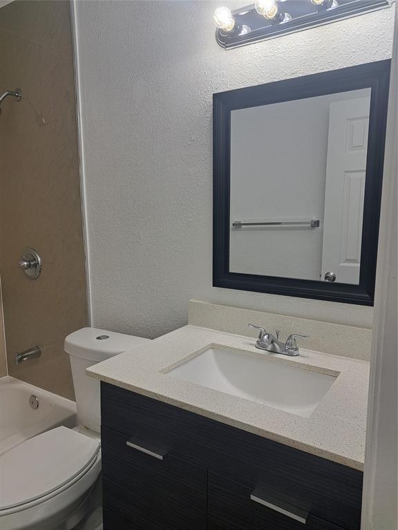 980 Southwest 76th Avenue, Unit 3 Pompano Beach, FL 33068 - Photo 23 of 32 a bathroom with a sink vanity and a toilet
