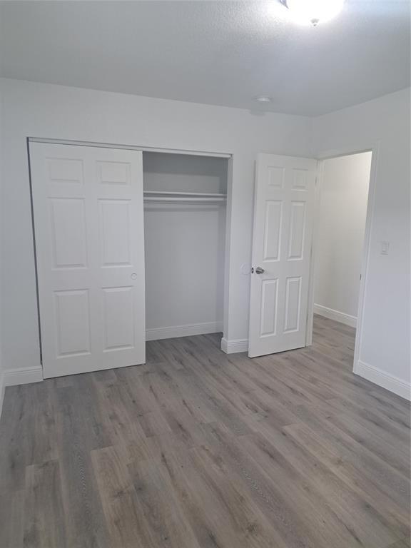 980 Southwest 76th Avenue, Unit 3 Pompano Beach, FL 33068 - Photo 25 of 32 a view of an empty room with wooden floor