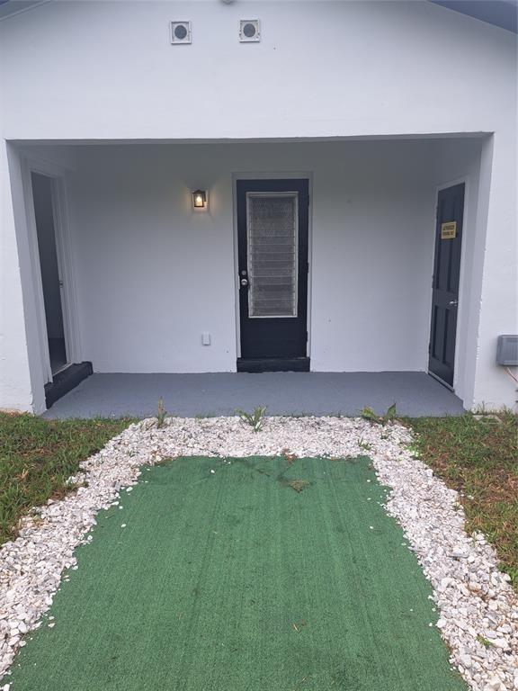 980 Southwest 76th Avenue, Unit 3 Pompano Beach, FL 33068 - Photo 26 of 32 a view of outdoor space yard and porch