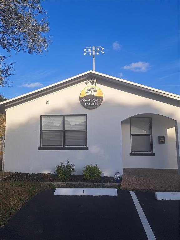 980 Southwest 76th Avenue, Unit 3 Pompano Beach, FL 33068 - Photo 30 of 32 a front view of a house with entryway
