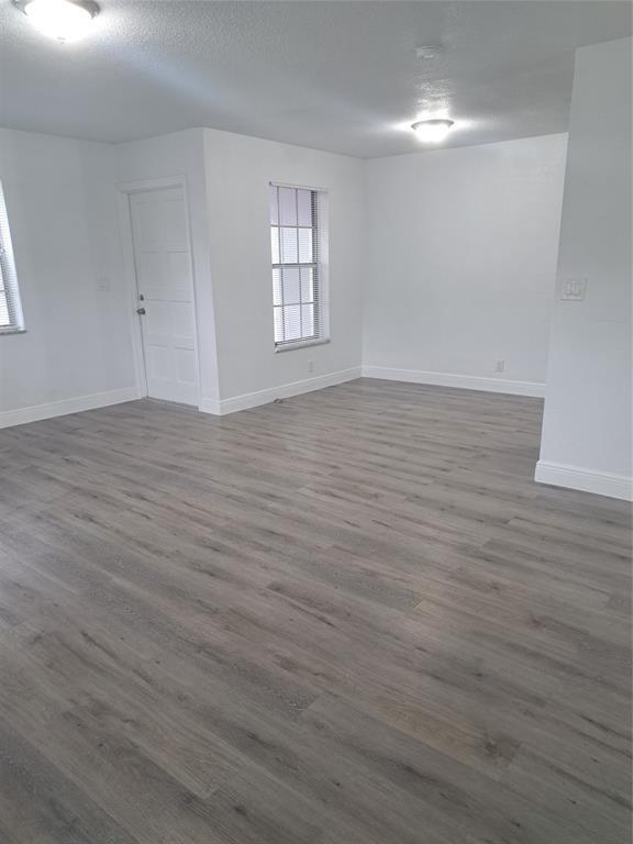 980 Southwest 76th Avenue, Unit 3 Pompano Beach, FL 33068 - Photo 10 of 32 wooden floor in an empty room with a window