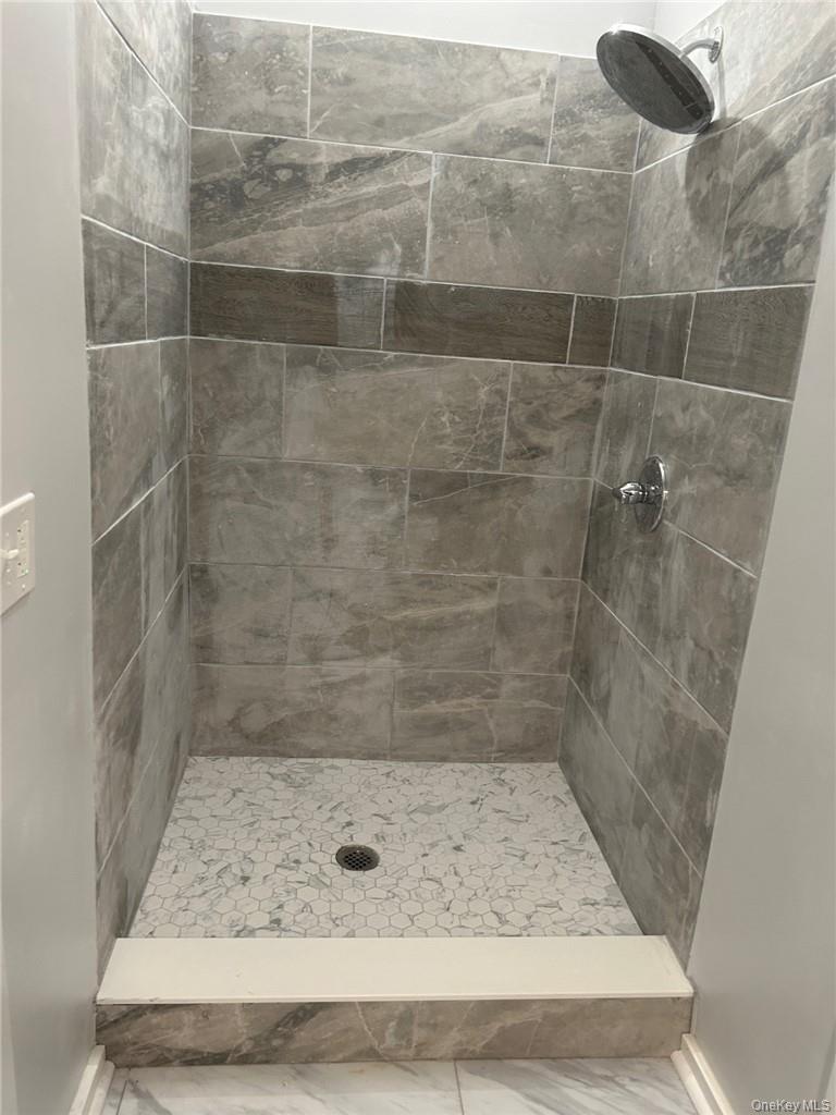 165 South Cross Road, Unit 4 Staatsburg, NY 12580 - Photo 6 of 12 Bathroom with tiled shower and tile flooring