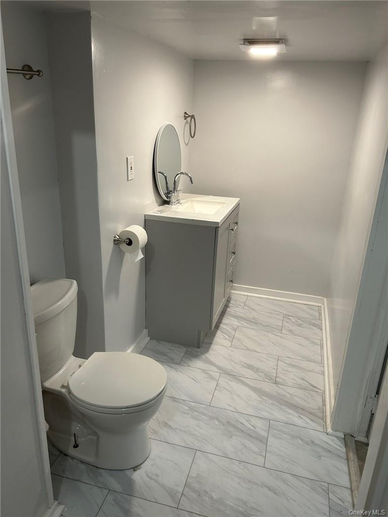 165 South Cross Road, Unit 4 Staatsburg, NY 12580 - Photo 7 of 12 Bathroom featuring tile flooring, vanity, and toilet