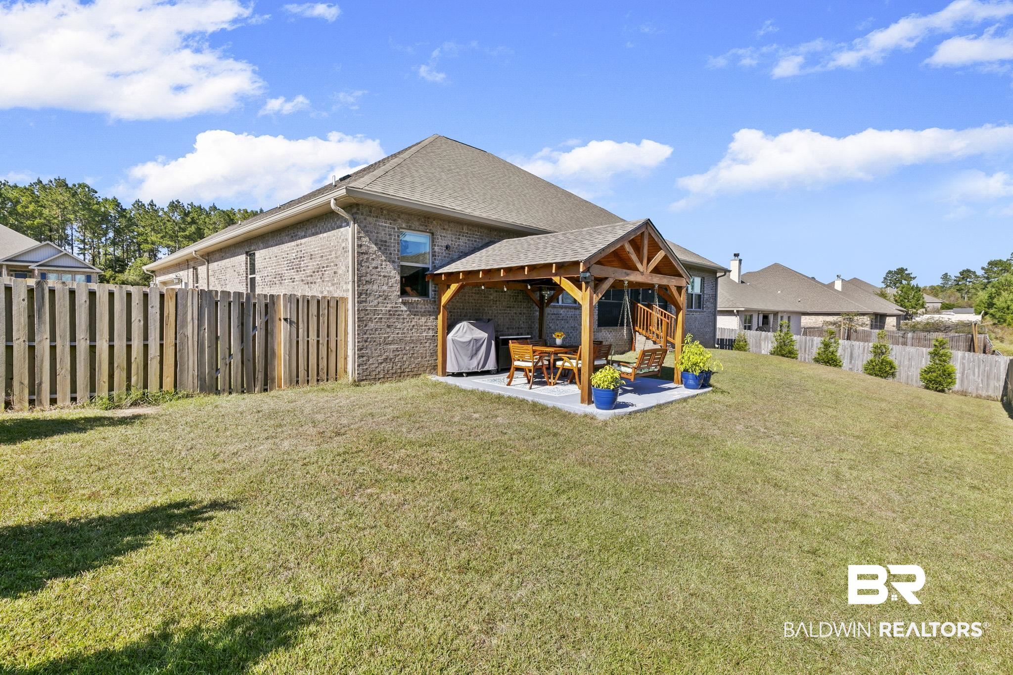 31500 Spoonbill Road Daphne, AL 36527 - Photo 51 of 85 Rear view of house featuring a patio and a yard