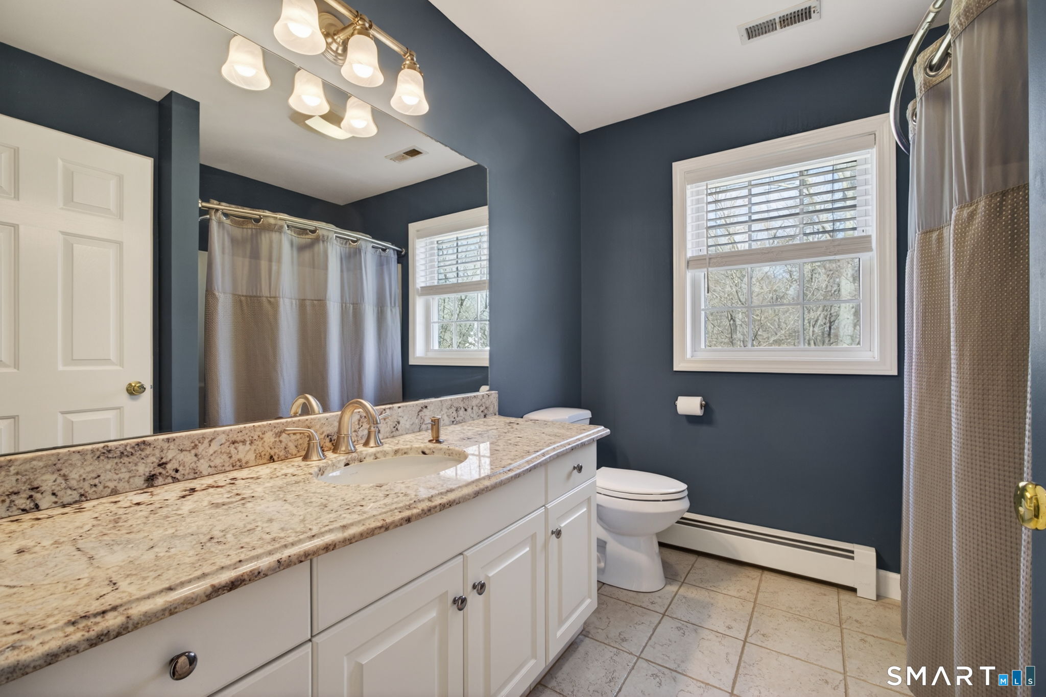12 Stonewall Lane Clinton, CT 06413 - Photo 20 of 32 a bathroom with a granite countertop sink a toilet and a mirror