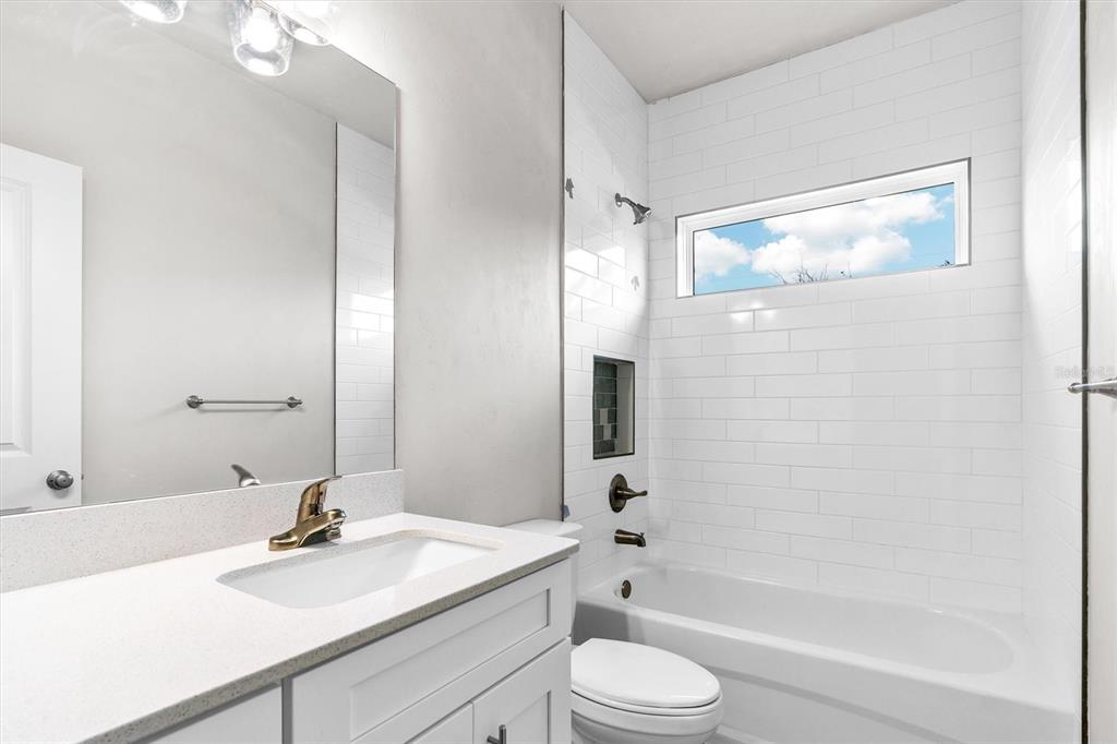 1140 Southwest 67th Street Gainesville, FL 32607 - Photo 13 of 65 a bathroom with a sink a toilet and shower