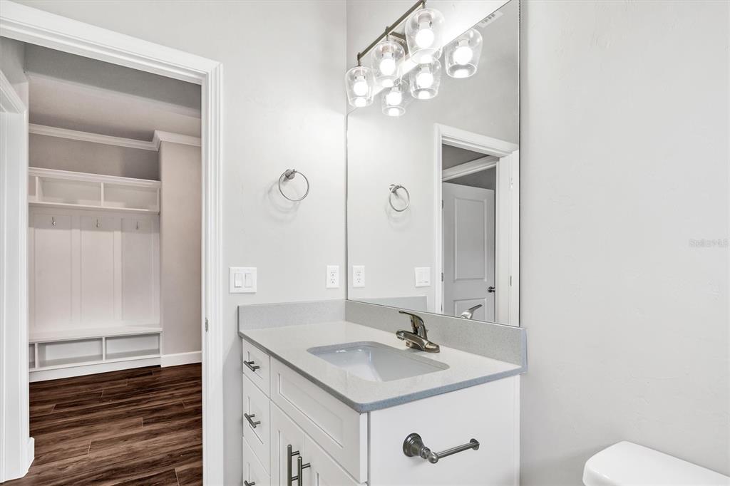 1140 Southwest 67th Street Gainesville, FL 32607 - Photo 14 of 65 a bathroom with a granite countertop sink and a mirror