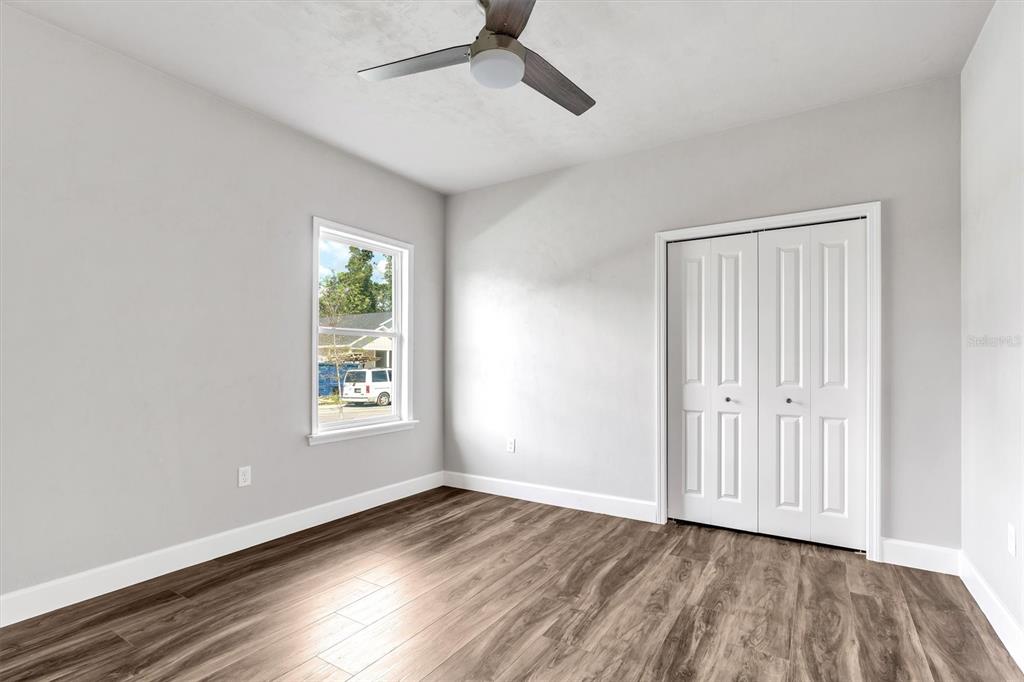 1140 Southwest 67th Street Gainesville, FL 32607 - Photo 16 of 65 a view of an empty room with wooden floor and a window