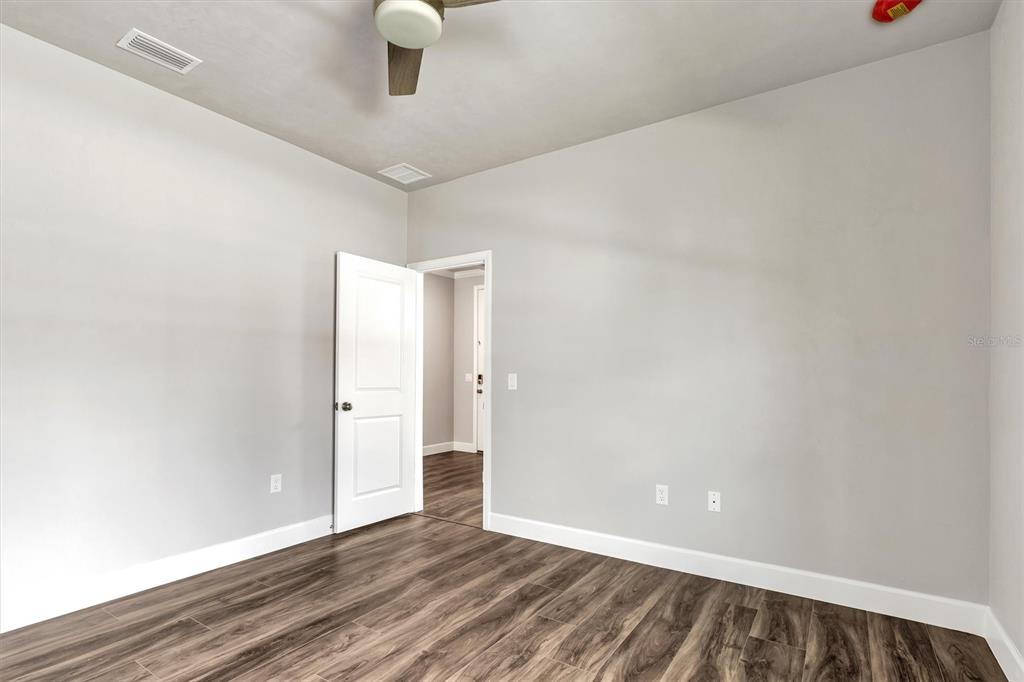 1140 Southwest 67th Street Gainesville, FL 32607 - Photo 18 of 65 a view of an empty room with wooden floor
