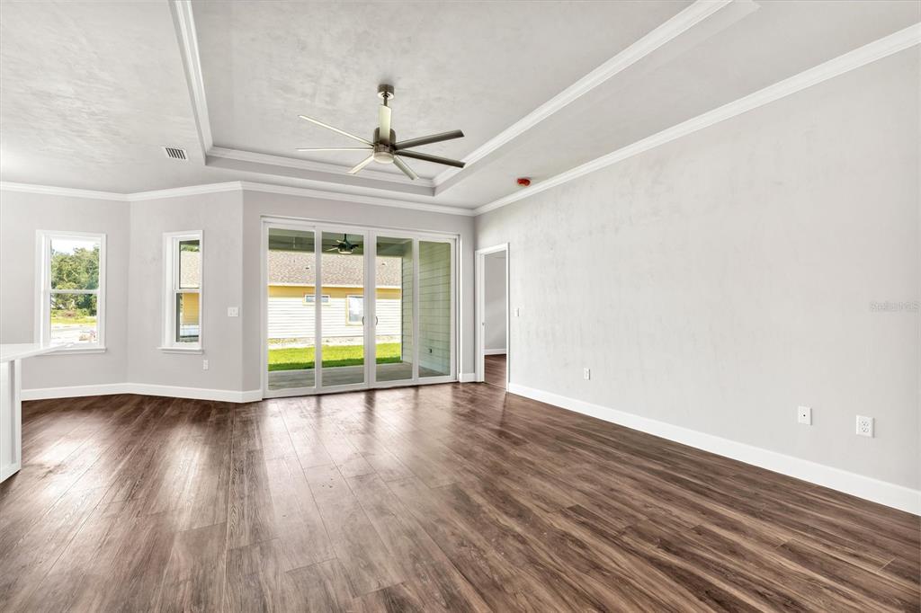 1140 Southwest 67th Street Gainesville, FL 32607 - Photo 20 of 65 a view of an empty room with wooden floor and a window