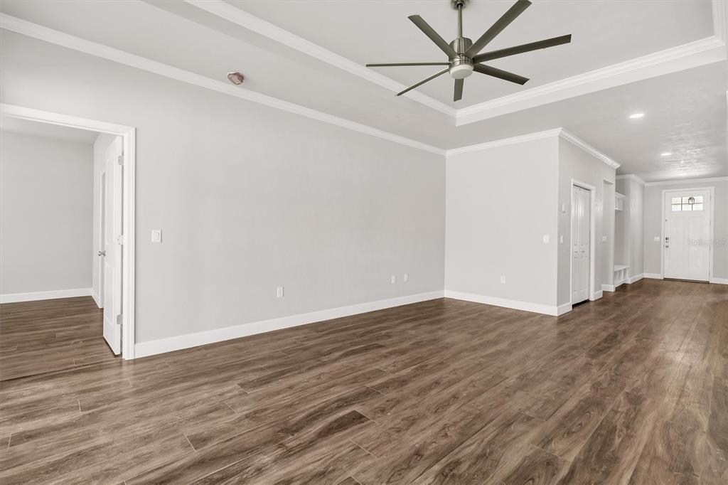 1140 Southwest 67th Street Gainesville, FL 32607 - Photo 22 of 65 a view of a livingroom with a hardwood floor and a ceiling fan