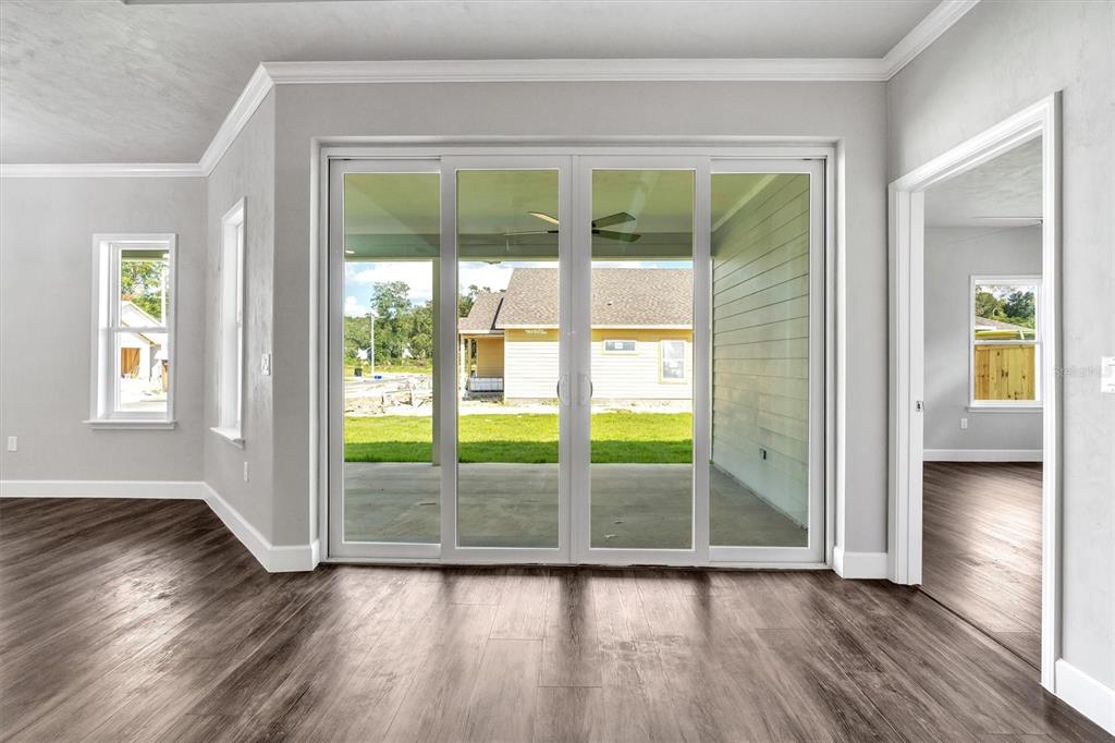1140 Southwest 67th Street Gainesville, FL 32607 - Photo 29 of 65 a view of an empty room and wooden floor and a window