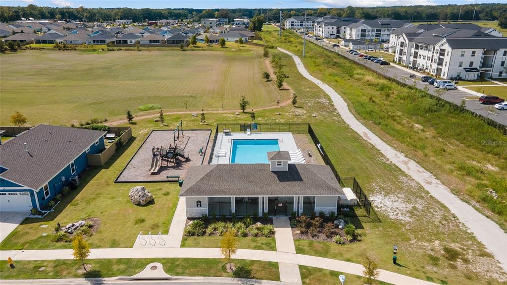 1140 Southwest 67th Street Gainesville, FL 32607 - Photo 57 of 65 a view of a swimming pool with outdoor seating and lake view