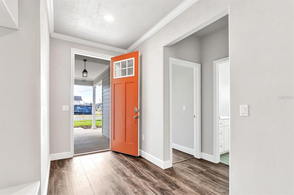1140 Southwest 67th Street Gainesville, FL 32607 - Photo 8 of 65 a view of hallway with an empty room and wooden floor