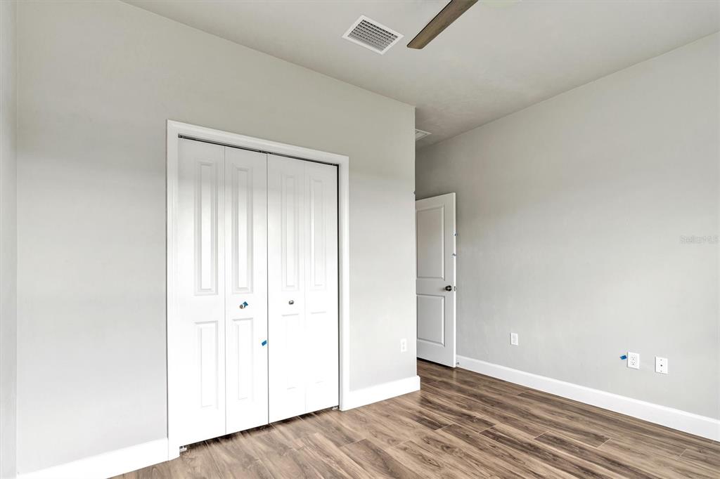 1140 Southwest 67th Street Gainesville, FL 32607 - Photo 10 of 65 an empty room with wooden floor and windows