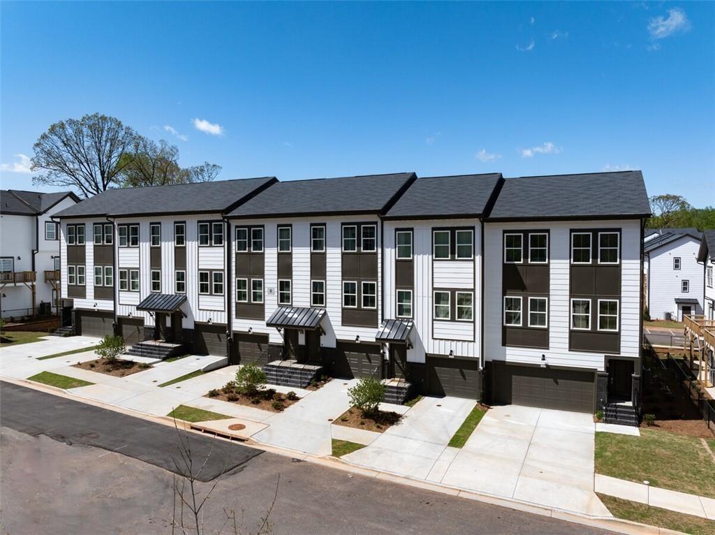 a view of a patio with couches table potted plants and floor to ceiling window