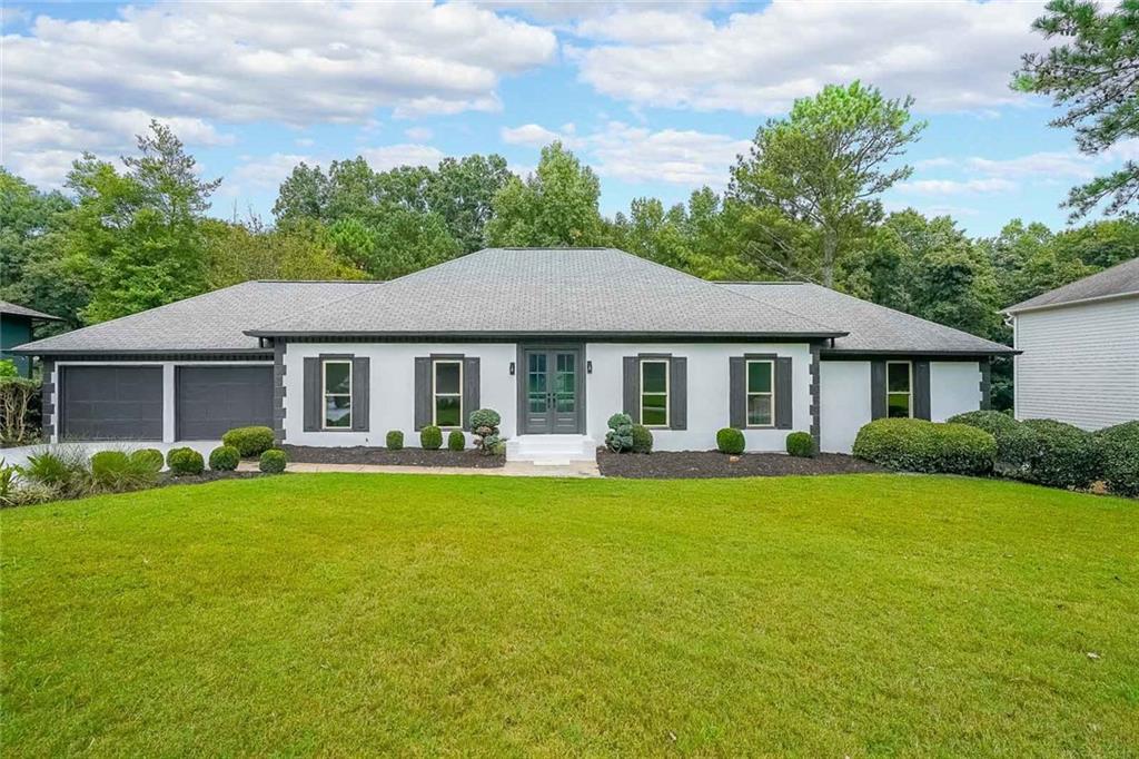 a front view of a house with swimming pool having outdoor seating