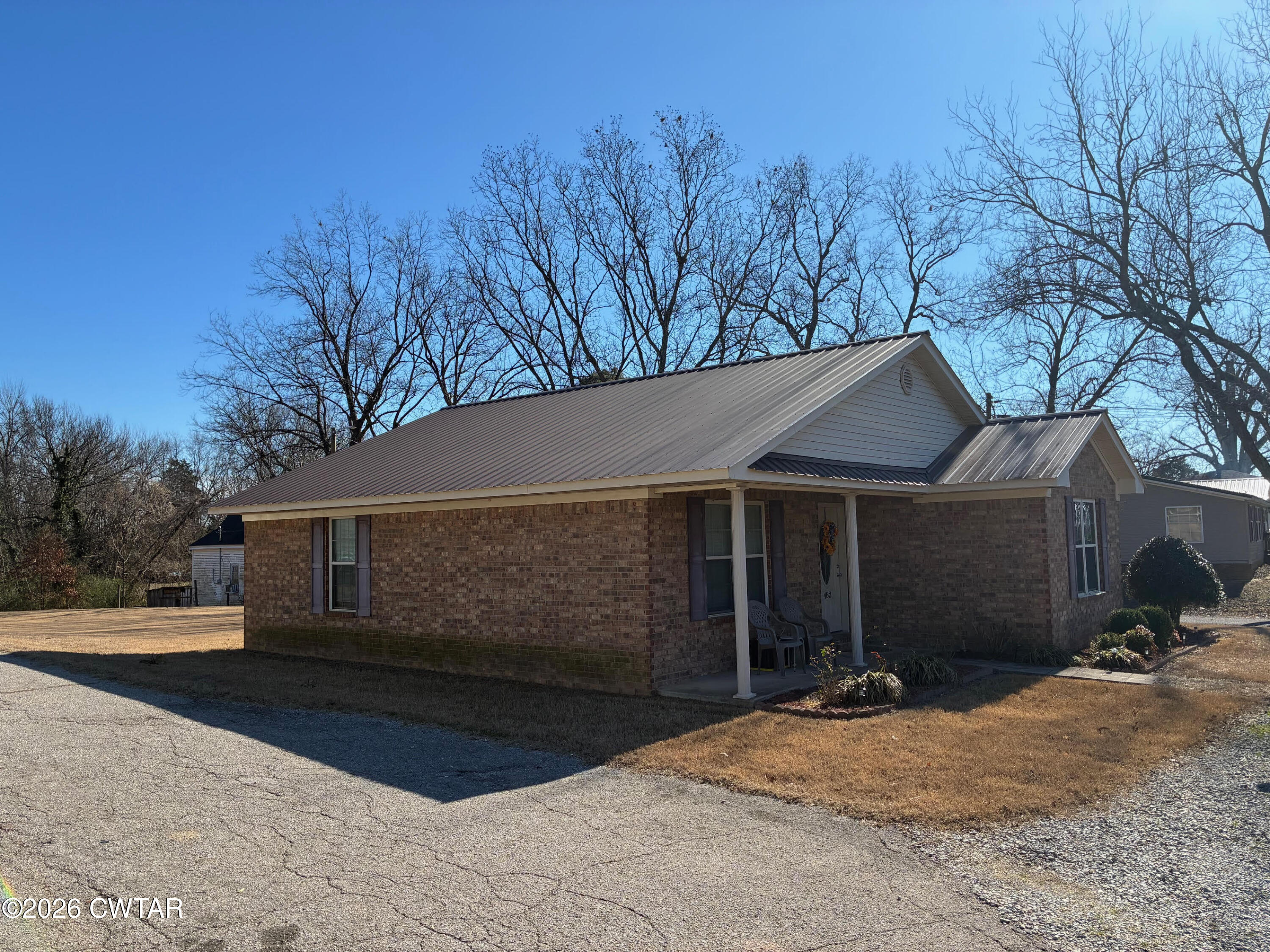482 Main Street Friendship, TN 38034 - Photo 6 of 27 a front view of house with yard and trees in the background