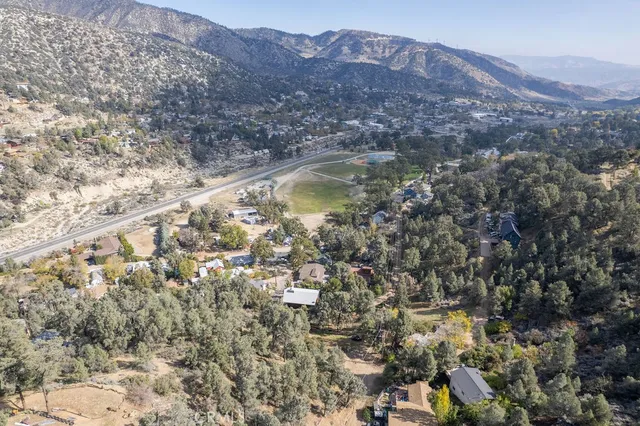 a view of a dry yard with mountains in the background
