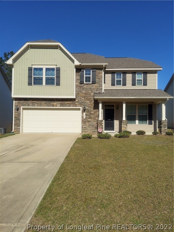 304 River Oak Street Spring Lake, NC 28390 - Photo 1 of 30 a front view of a house with a yard