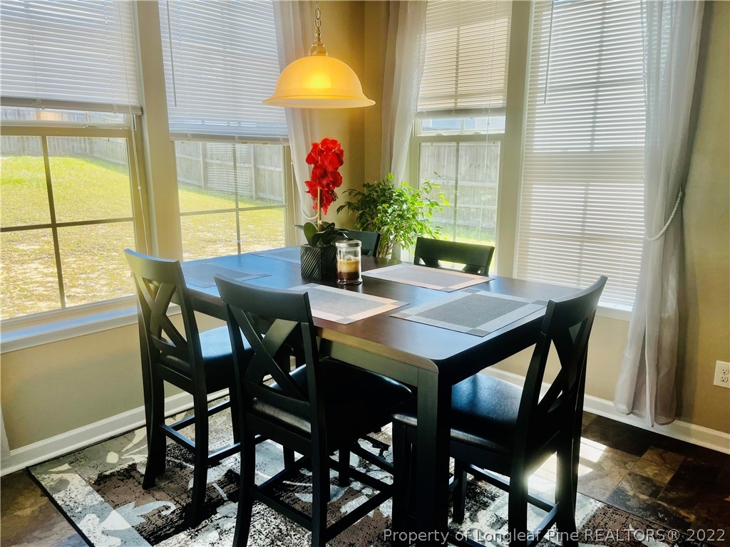 304 River Oak Street Spring Lake, NC 28390 - Photo 15 of 30 a view of a dining room with furniture and a window