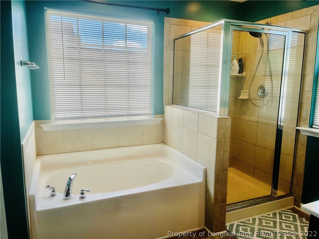 304 River Oak Street Spring Lake, NC 28390 - Photo 17 of 30 a bathroom with a bathtub and a shower