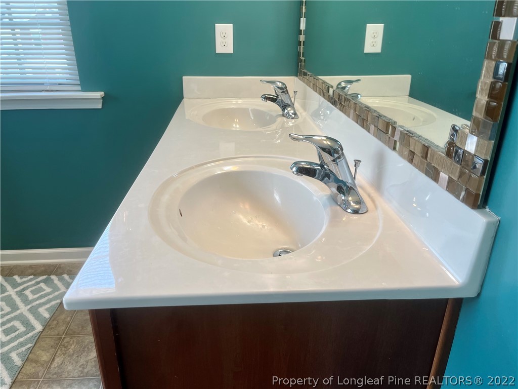 304 River Oak Street Spring Lake, NC 28390 - Photo 18 of 30 a bathroom with a sink and a mirror