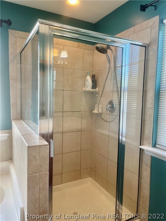 304 River Oak Street Spring Lake, NC 28390 - Photo 20 of 30 a bathroom with a glass shower door