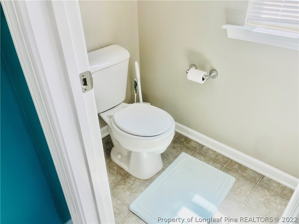 304 River Oak Street Spring Lake, NC 28390 - Photo 23 of 30 a white toilet sitting next to a white cabinet