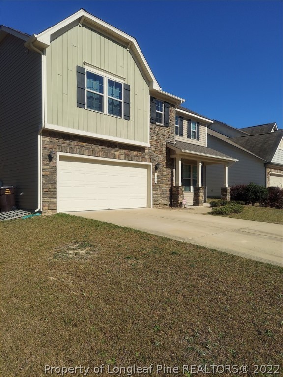 304 River Oak Street Spring Lake, NC 28390 - Photo 25 of 30 a front view of a house with a yard