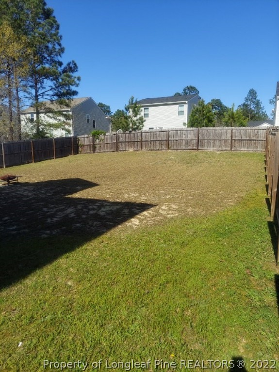 304 River Oak Street Spring Lake, NC 28390 - Photo 27 of 30 a view of a large yard with an outdoor space