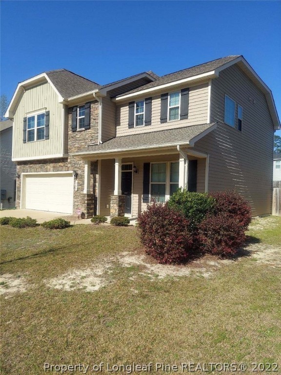 304 River Oak Street Spring Lake, NC 28390 - Photo 30 of 30 a front view of a house with a garden