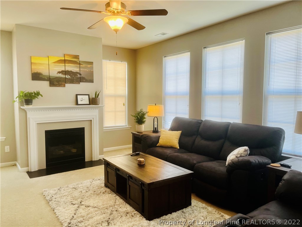 304 River Oak Street Spring Lake, NC 28390 - Photo 5 of 30 a living room with furniture and a fireplace
