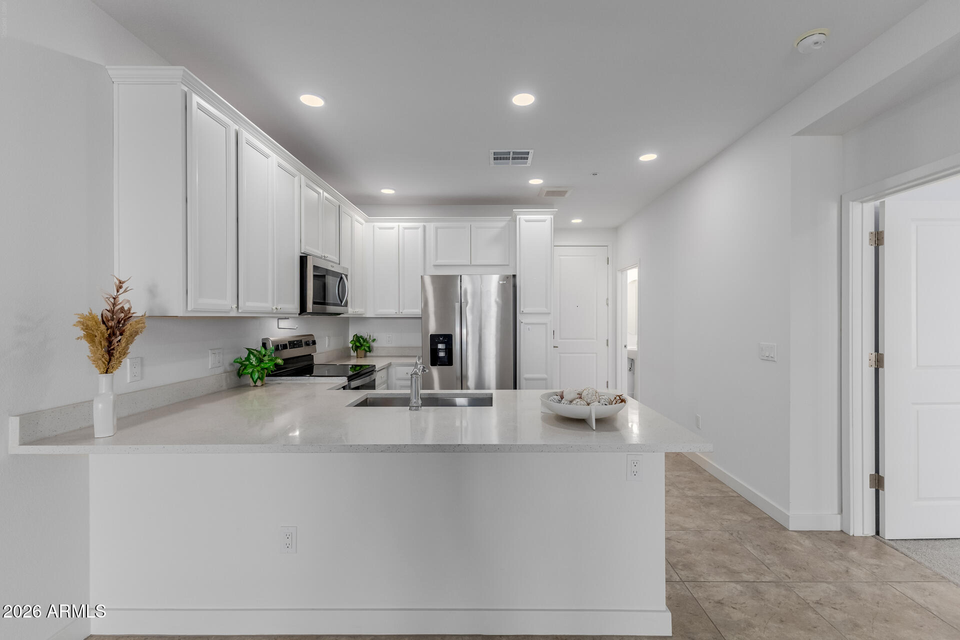 2511 West Queen Creek Road, Unit 279 Chandler, AZ 85248 - Photo 8 of 35 a kitchen with stainless steel appliances granite countertop a refrigerator and a sink