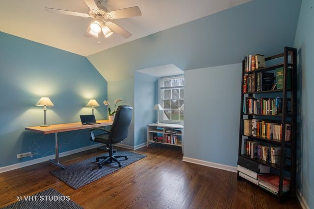 a view of a workspace with furniture and a bookshelf