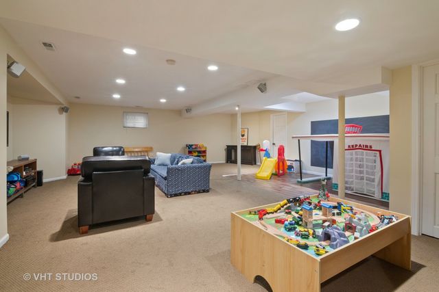 a living room with furniture and a pool table