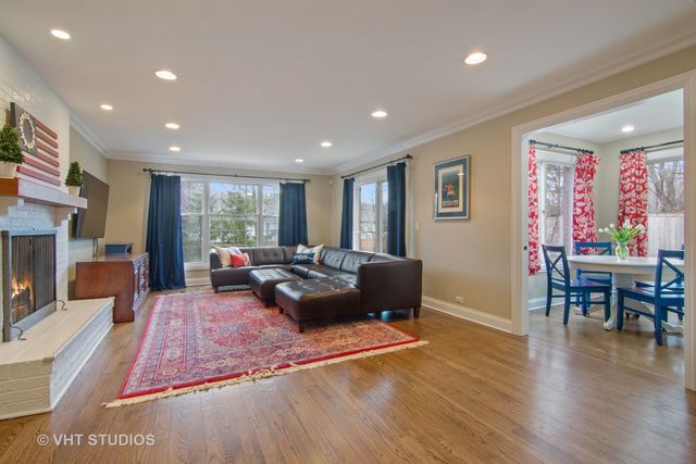 a living room with furniture rug and wooden floor