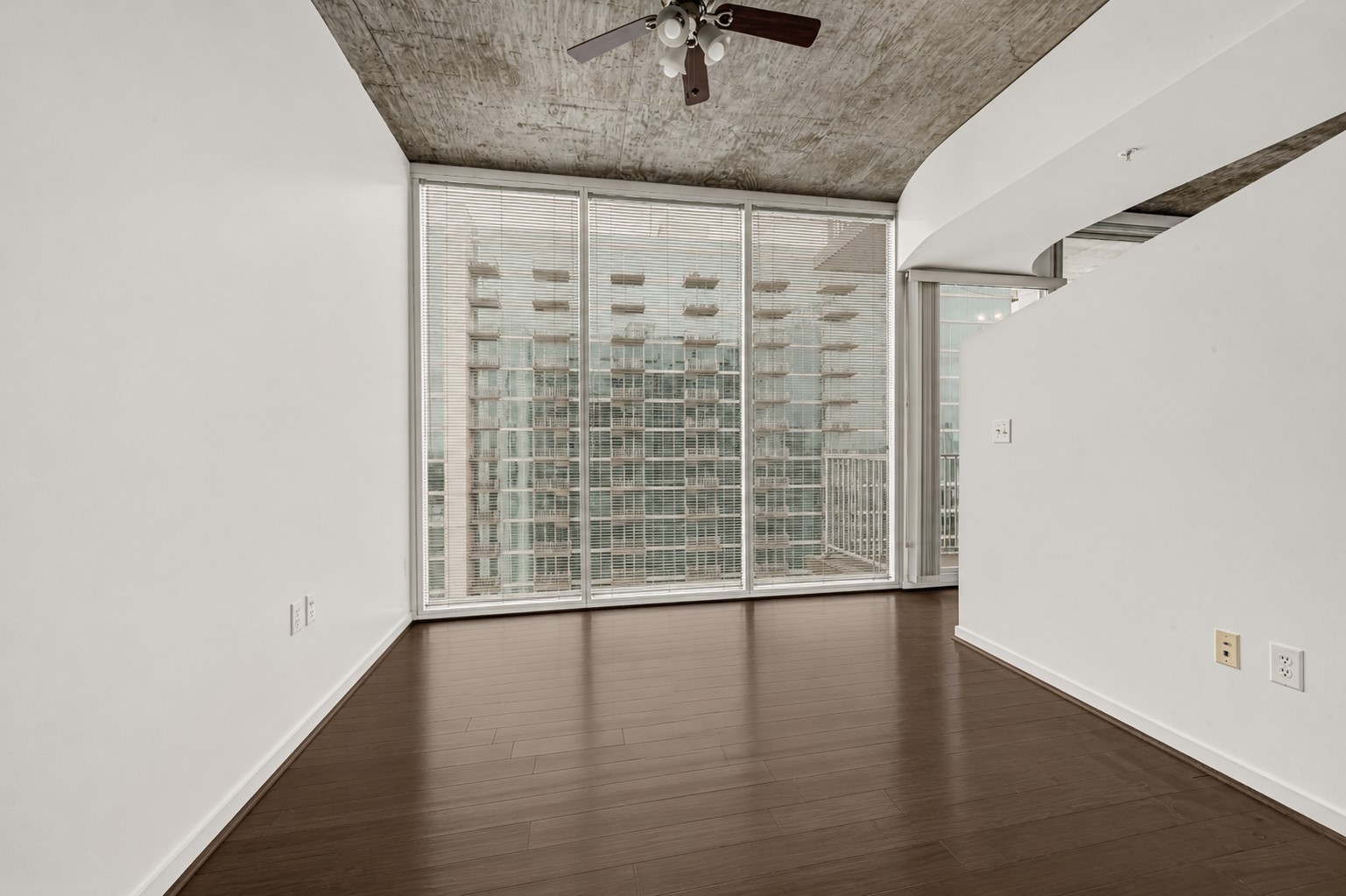 5925 Almeda Road, Unit 12308 Houston, TX 77004 - Photo 10 of 48 a view of an empty room with wooden floor and a window